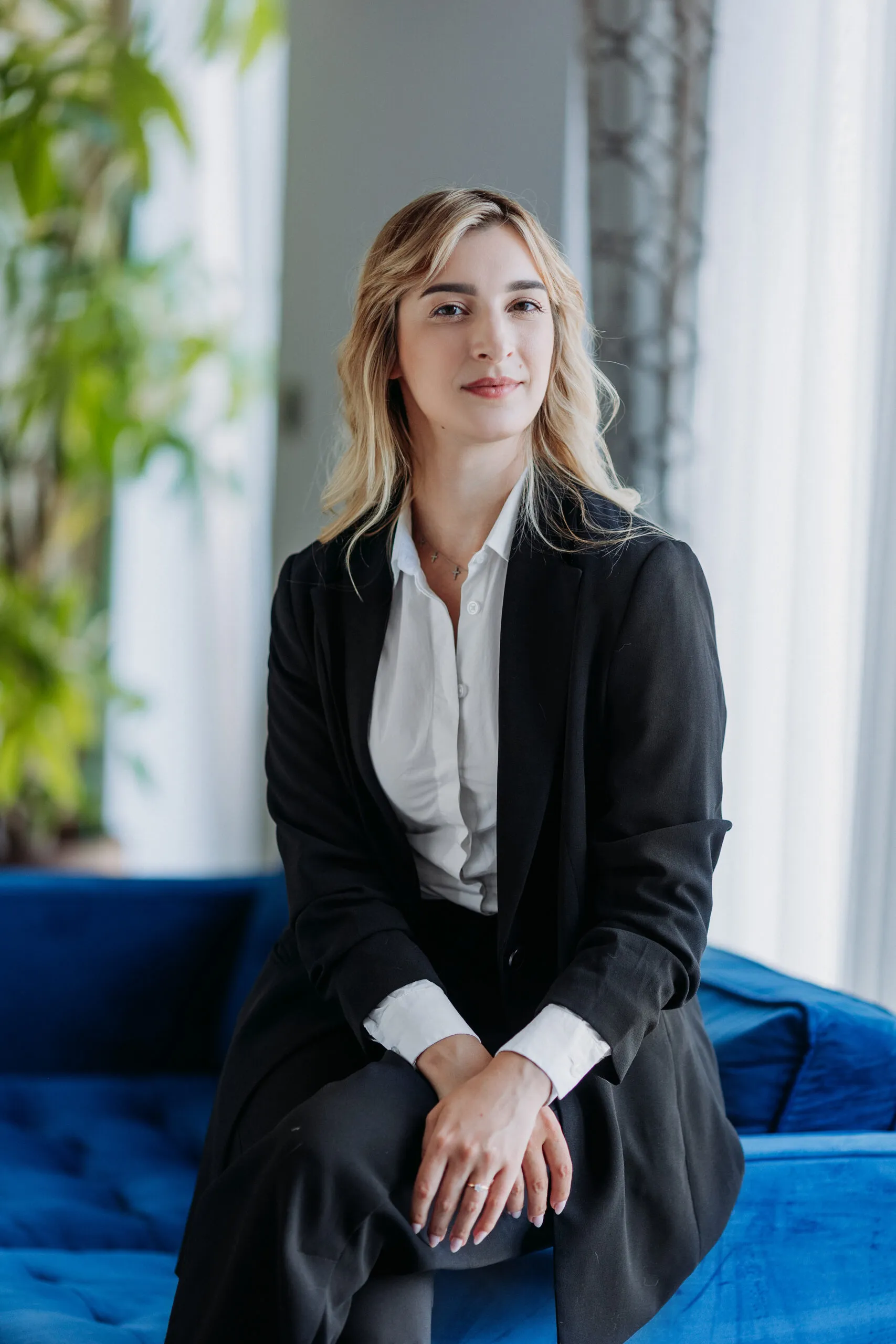 Miruna Zamfiriu seated against an indigo velvet sofa